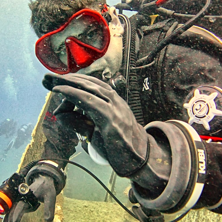 Piers, who builds ScubaOS, in a red mask and drysuit on a wreck